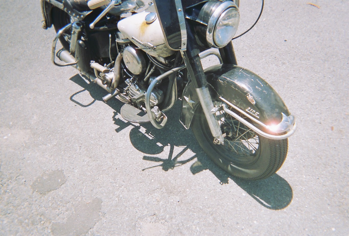 Close-up of a vintage motorcycle on a concrete surface
